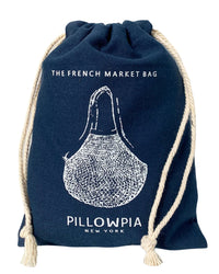 The French Market Bag No.2 in Navy by PILLOWPIA features white rope handles, printed branding, and a charming illustration—an organic cotton bag for stylish, sustainable carrying.