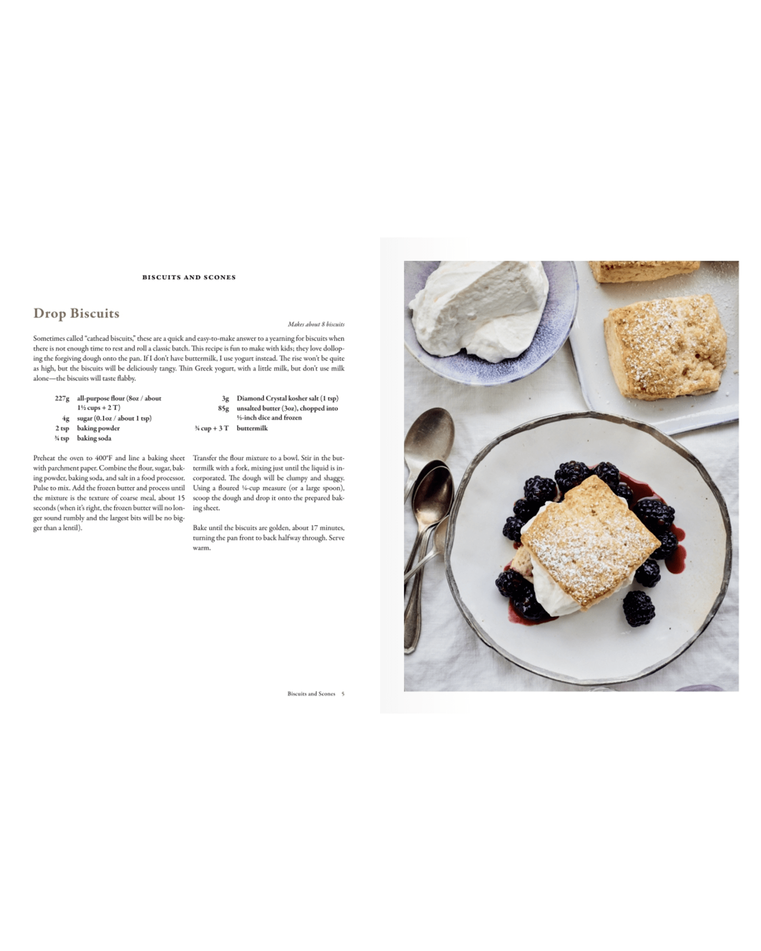 A plate with a drop biscuit topped with whipped cream and berry compote sits beside more biscuits and a bowl of whipped cream—perfect baking inspiration from Delectable by Random House, with the recipe printed on the left page.