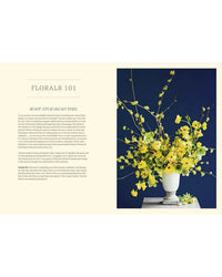 Floral arrangement in a white vase on a navy background with text on a beige sidebar.