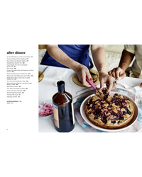 Two people cut and serve a berry-topped cake at a table set with small plates and a bottle, evoking easy entertaining ideas from Nothing Fancy by Random House; a printed dessert menu appears on the left.