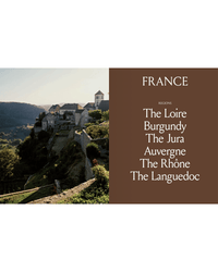 A sunset view of a French hilltop village with a brown panel featuring French wine regions famous for natural wine—The Loire, Burgundy, The Jura, Auvergne, The Rhône, and Languedoc—highlighted in Spilled Natural Winemakers Stories & Recipes by Random House.