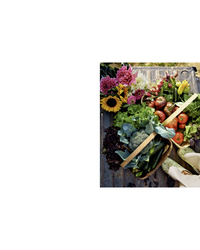 A basket of fresh veggies and greens beside cut flowers inspires dinner party recipes from The Wishbone Kitchen Cookbook by Random House.
