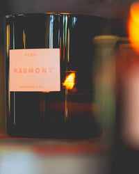 The Le Grand Marmont candle by ROEN features luxury fragrance, a visible flame, and is hand poured in California with coconut soy wax in dark glass.