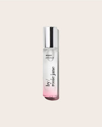Rosie Janes Perfume Oil in Missy comes in a clear glass bottle with a silver cap, minimal black text, and a touch of pink at the base, reflecting its tropical scent, all set against a light beige background.