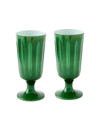 Two Empire Footed Ale Malachite goblets by SIR / MADAM, each with vertical grooves, a short stem, and a wide base, are displayed against a plain white background. This set includes 2 green vintage-style glasses.
