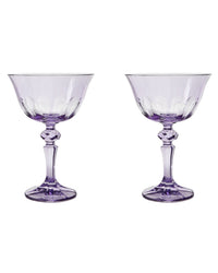 Two Rialto Glass Coupe Amethyst glasses by SIR / MADAM, each with faceted stems, are displayed side by side on a white background.