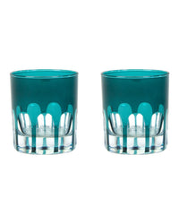 The SIR / MADAM Rialto Glass Old Fashion Millicent Set/2 includes two short round glasses with teal tops, clear bases, and a scalloped Venice bridge design—hand-finished glassware to elevate any table setting.