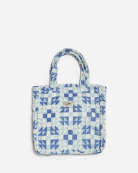 The Dream Terry Tote Bag in Lagoon by Slowtide features a blue and white pattern, two handles, and a small front label. Made from sustainably sourced cotton, it’s set against a plain light background.