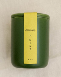 The LEIF Dandelion & Mint Candle is a green ceramic jar with a yellow label, 4 oz soy wax blend, shown against a neutral background.