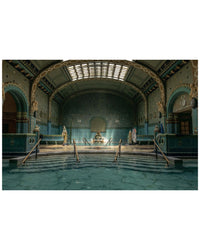 Hot Springs by Random House features an ornate indoor pool with turquoise tiles, decorative arches, statues, and stairs leading into the water as natural light streams through a large skylight—evoking ancient thermal baths.