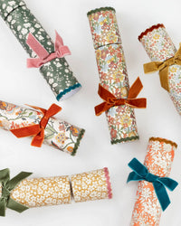 Meri Meri x Liberty Fall Crackers with Velvet Bows—luxury party crackers wrapped in Liberty floral prints and tied with colorful velvet—are perfect for adding elegance to your fall dinner table.