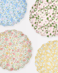 The Meri Meri X Liberty Mixed Set Reuseable Large Plates features four scalloped-edge plates by Meri Meri, each with vibrant floral Liberty-inspired patterns in blue, pink, yellow, and multicolored hues.
