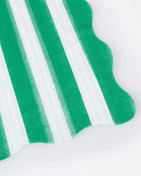 The Meri Meri Festive Stripe Small Napkins feature green and white scalloped stripes, shown in a close-up against a plain white background.