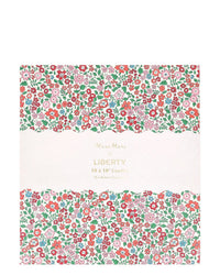 The Meri Meri x Liberty Sweet Meadow Candle Gift Box features a square box with a red, pink, and green Liberty floral print, gold-embossed branding, and ten 25.4cm ridged table candles—perfect for any occasion.