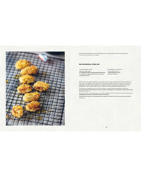 Breaded, pan-fried Mussels from Simon & Schuster cool on a black wire rack beside a cookbook page showing Sergio Hermans citrus and chili pan-fried mussels recipe.