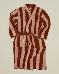 The Hawkins New York Simple Striped Terry Bathrobe in Blush/Terracotta is a 100% cotton robe with wide vertical stripes, long sleeves, belted waist, and two front pockets, shown laid flat on a light beige background.