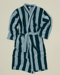 A Hawkins New York Simple Striped Terry Bathrobe in Sky/Peacock, with long sleeves and a belt, shows alternating vertical dark green and light blue stripes. It is laid flat on a light beige background.