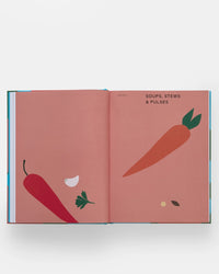 An open copy of The Spanish Mediterranean Islands Cookbook by Phaidon Press shows minimalist illustrations of a carrot, chili pepper, garlic, parsley, and black bean on pink pages with the chapter title Soups, Stews & Pulses.