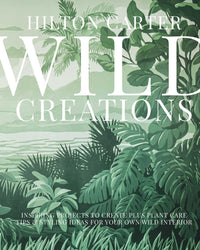 The book cover for Wild Creations by Simon & Schuster features illustrated tropical plants, a jungle landscape, and lush mountains—an inspiring scene for wild plant care and creative DIY projects.