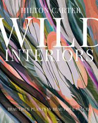 Book cover for Wild Interiors by Simon & Schuster, featuring abstract plant-themed art and the subtitle Beautiful Plants in Beautiful Spaces—ideal for inspiration on decorating with plants and creating stylish interiors.