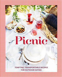 A picnic setup with plates, cutlery, bread, olives, rosé glasses, wine bottle, and thermos on a white cloth with red gingham border. Text: "Picnic" by Simon & Schuster—tempting picnic recipes for al fresco dining.