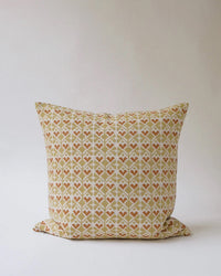 The Soil to Studio Neelima Linen Pillow – 18 x 18 is a soft, plush linen pillowcase featuring a beige, brown, and muted orange geometric pattern inspired by traditional Indian hand block-printed designs.