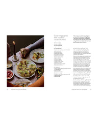 A cozy table set for two with plates of crispy gyoza and cucumber salad, candlelit for ambiance. The recipe, "Spicy Crispy Gyoza with Smashed Cucumber Salad," is from Chronicle Books' A Meal For Two.