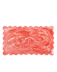 A 14in pink rectangular cheese board with scalloped edges and a marbled white swirl, by Casa Amarosa, displayed against a white background.