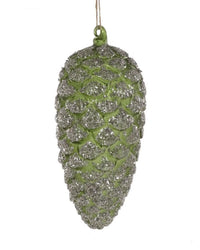 The Cody Foster Forest Floor Pinecone Ornament in Olive Green, adorned with silver glitter, hangs by a string against a white background.