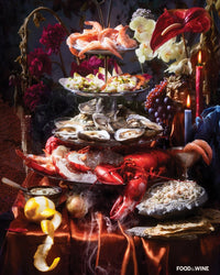 A tiered seafood tower with shrimp, oysters, lobster & crab is featured on the Tiers of Joy - Food+Wine Collab 1000 Piece Puzzle by Piecework Puzzles, displayed with candles and fruit on satin. Food & Wine logo appears in the corner.