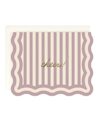The Amy Heitman Cheers! Striped | Single Card features wavy edges, vertical pastel pink and cream stripes, and "cheers!" in gold foil script at the center. Comes with a white envelope; interior is blank.
