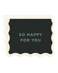 Amy Heitman’s "So Happy For You - Wave Edge" single card features a black front with a wavy cream border and green "SO HAPPY FOR YOU" text. It comes with an off-white envelope and has a blank interior.