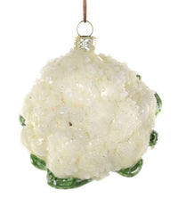 The Cody Foster Farm Fresh Cauliflower Ornament is a hand-crafted glass decoration shaped like a head of cauliflower, featuring white florets, small green leaves at the base, and hung by a brown string.