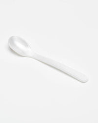 The etúHOME Acrylic Dipping Spoon in Pearl is displayed on a plain light gray background, positioned diagonally from the bottom right to top left.