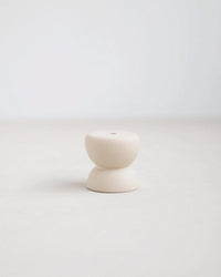 The Floral Society’s Gem Petite Long Stem Candleholders in Sand feature a minimalist off-white ceramic design with two stacked, rounded shapes and a top hole—ideal for modern home decor. Set against a plain light background.