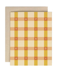 The Amy Heitman "Birthday Golden Check" card features a beige and yellow plaid design with "HAPPY BIRTHDAY" spelled out in letters and stars. It includes a coordinating envelope and has a blank interior for your message.