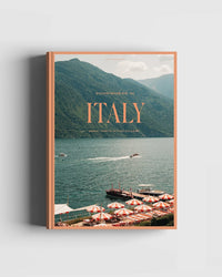 Book cover for “Travel Guide: Somewhere in Italy” by Cozy Publishing features Italy’s scenic lakeside with mountains, boats, and red-and-white dock umbrellas—ideal for travel lovers dreaming of Italian regions and hidden trattorias.