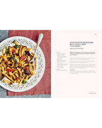 A plate of stir-fried mushrooms with Thai basil and vegetables sits atop a pink napkin, fork on the side. Explore easy Thai recipes from "Thai Made Easy" by Chronicle Books; recipe text appears to the right.