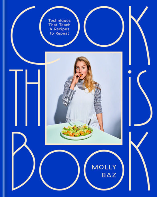 A woman in a striped shirt and white apron eats salad with Cook This Book by Random House, a foundational cookbook featuring essential techniques and repeat-worthy recipes, against a blue background with bold yellow title text.