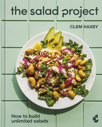 Book cover for The Salad Project by Random House, showing a colorful salad with greens, avocado, potatoes, red onions, herbs, and cheese on a white plate over light green tiles. Includes the text: A cookbook of unlimited salad recipes.