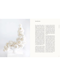 A sculptural display of white, flower-like pom-poms curves atop a pedestal, echoing the elegance found in "The Flower School" by Chronicle Books. On the right, text opens with "Introduction" in black serif font.