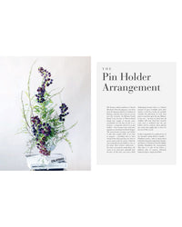 A floral design with purple blooms and greenery sits in a white vase on stacked books. Next to it, text reads The Flower School by Chronicle Books, followed by a descriptive paragraph about the product.