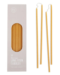 On the left, a box of 12 The Floral Society Beeswax Long Stem Candles is shown; on the right, three individual yellow candles are displayed against a white background.