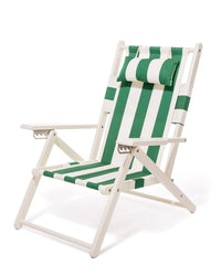 The Tommy Chair - Acacia White - Crew Canyon Green Stripe by Business & Pleasure Co features green and white striped outdoor canvas, wooden frame, armrests, and matching headrest pillow, shown on a plain white background.