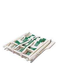 The Tommy Chair - Acacia White - Crew Canyon Green Stripe by Business & Pleasure Co features a compact, foldable design with green and pink woven straps, showcased on a white surface for easy portability.