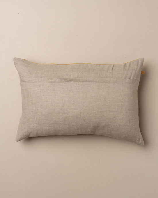 The Saarde Velvet Lumbar Pillow w/ Feather Insert in Nutmeg is shown in a rectangular shape with a plain fabric cover, displayed against a neutral beige background.