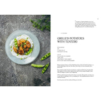 Grilled Potatoes with Tzatziki from Cozy Publishing’s Four Seasons of Cabin Cooking features potatoes, tzatziki, dill, and pea pods for a taste of Nordic seasonal cuisine.