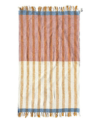 The Suave Miel - Blanket Roll by caminito is a rectangular, handwoven Mexican blanket with pink and brown stripes on top, cream and yellow below, blue-fringed borders at both ends, and classic vertical striping.