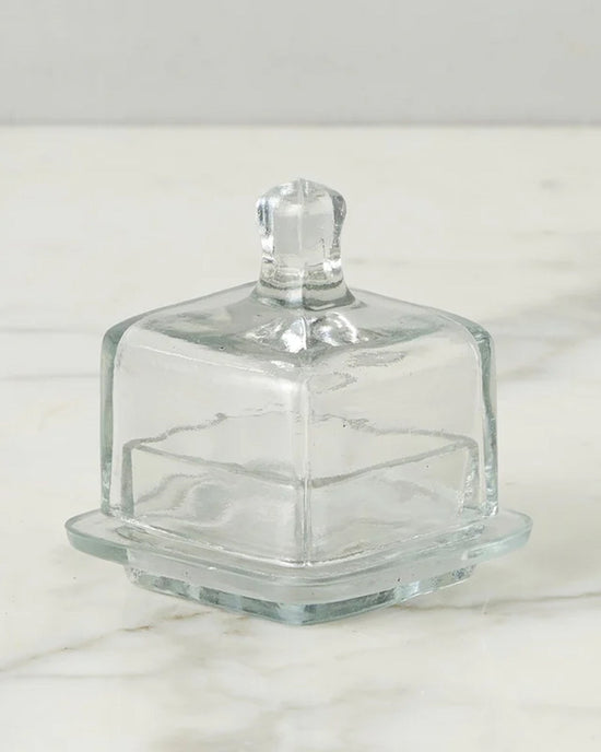 The etúHOME Bistro Glass Jam Jar, Square, is shown with a lid on a white marble surface.