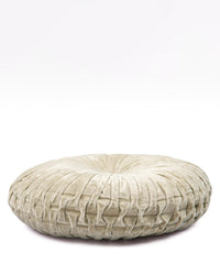 The Velvet Round Pillow in Biscotti by Casa Amarosa features a handcrafted pleated design, tufted center, and light beige velvet cover. This decorative floor cushion is displayed against a plain white background.